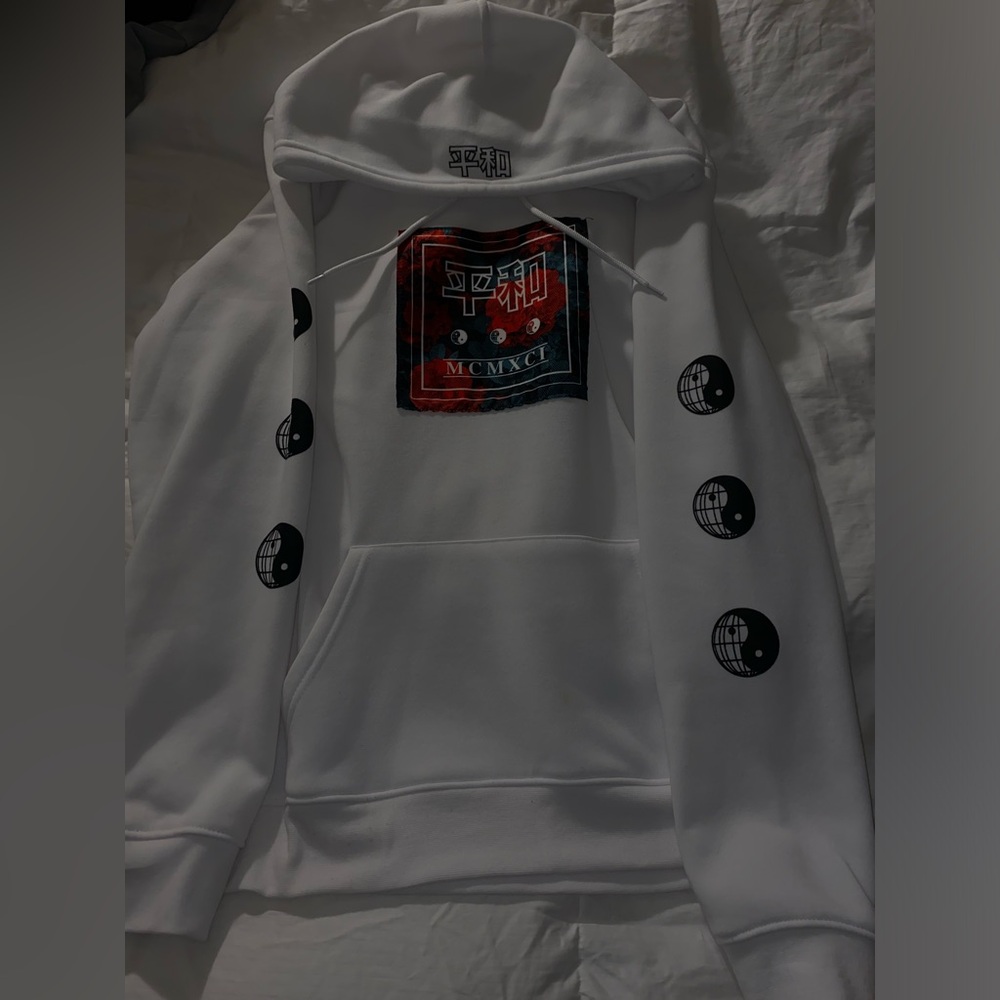White hoodie with yin&yang symbols on both sleeves and japanese characters.